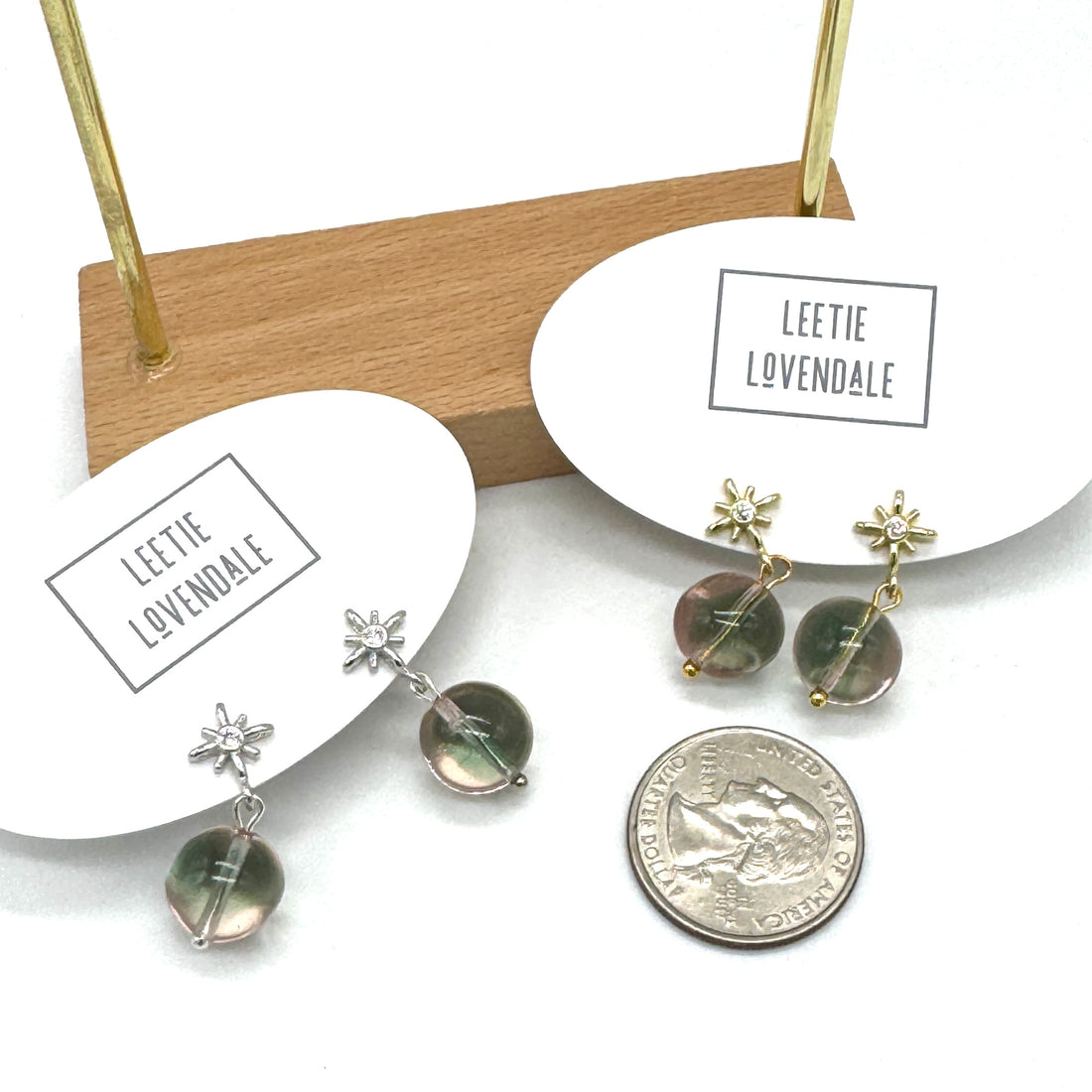 Pair of earrings on a stand with &