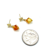 Gold earrings with amber-colored beads next to a U.S. quarter for scale on a white background