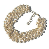 Multi-layered pearl necklace on a white background