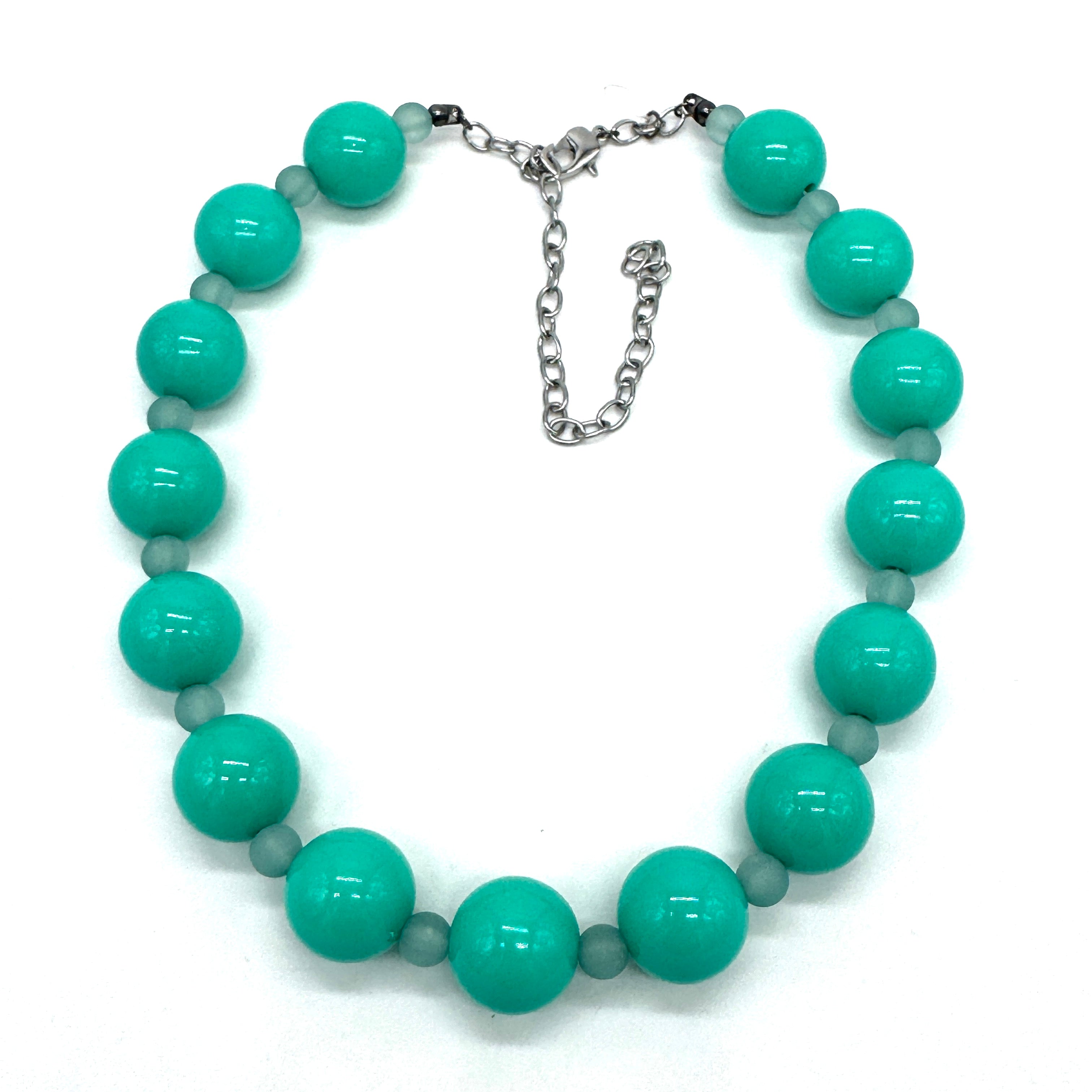 Turquoise beaded necklace on a white background