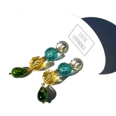 Colorful beaded earrings on a white background with &