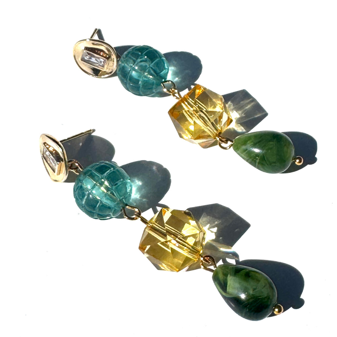 Multicolored gemstone earrings on a white background