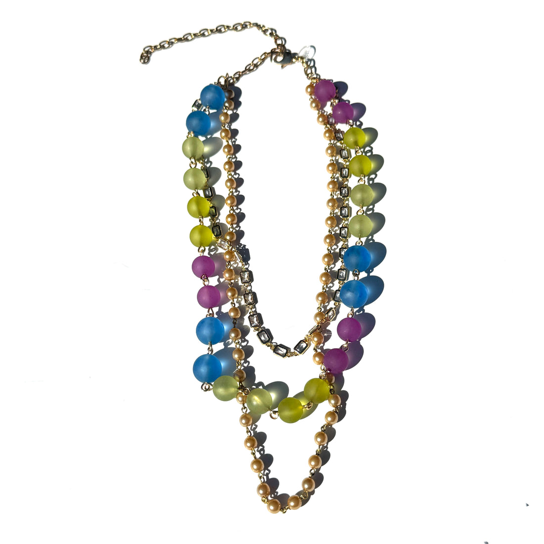 Colorful beaded necklace with gold chain on a white background