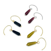 Set of three earrings with different colored beads on a white background