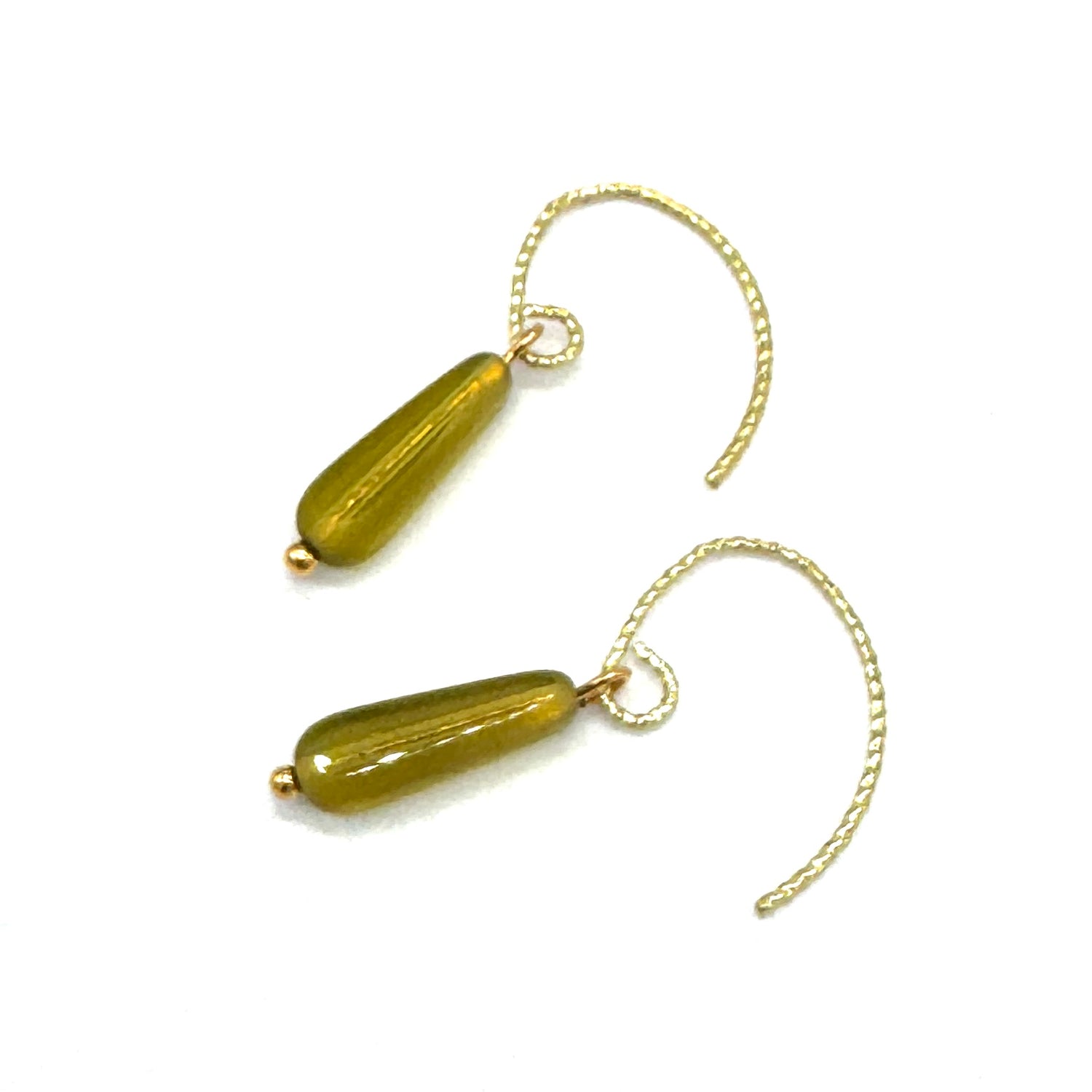 Pair of gold earrings with green beads on a white background
