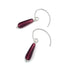 Pair of red teardrop-shaped earrings with silver chains on a white background