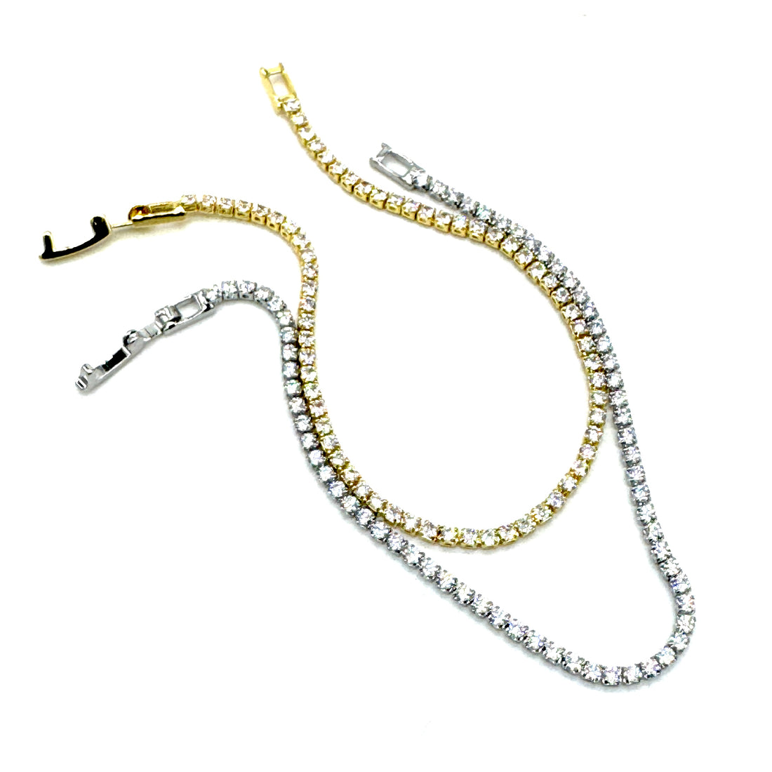 Two diamond tennis chains, one gold and one silver, on a white background.