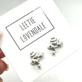 Silver frog-shaped earrings on a card with &