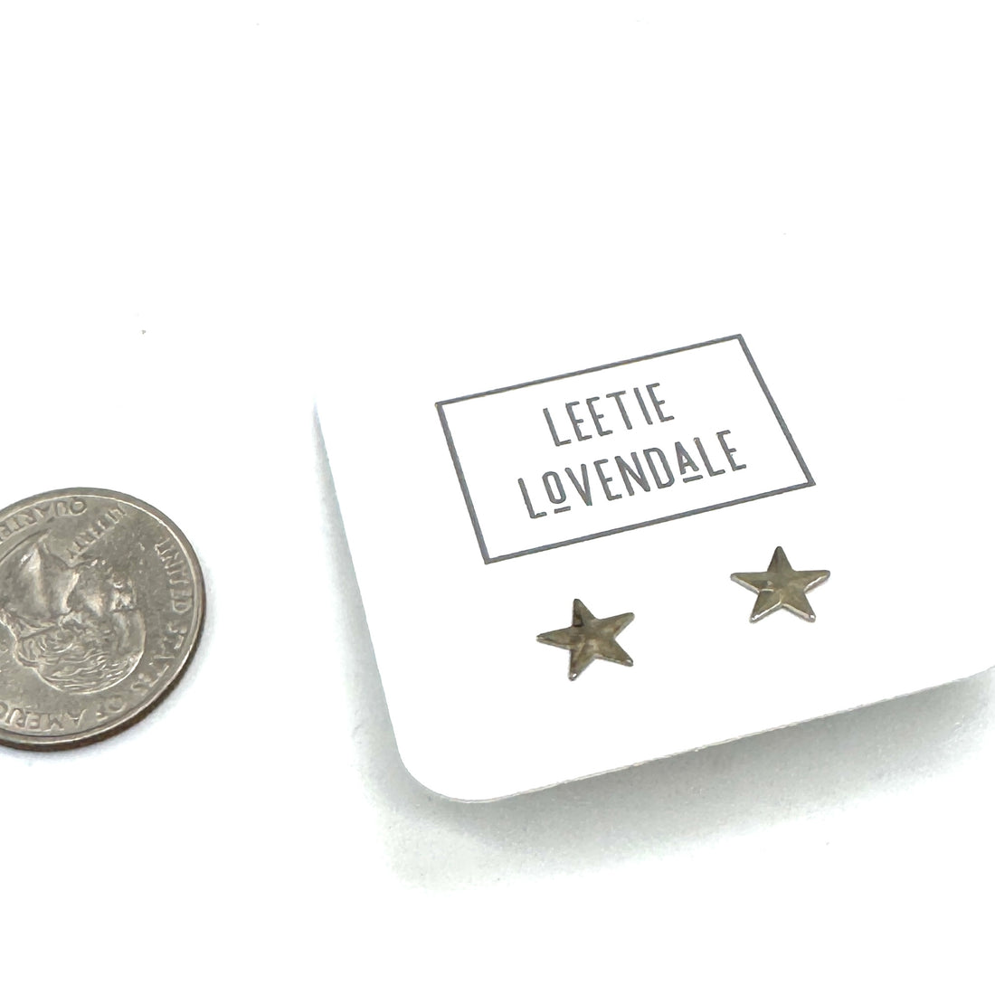 Star-shaped earrings on a card with &