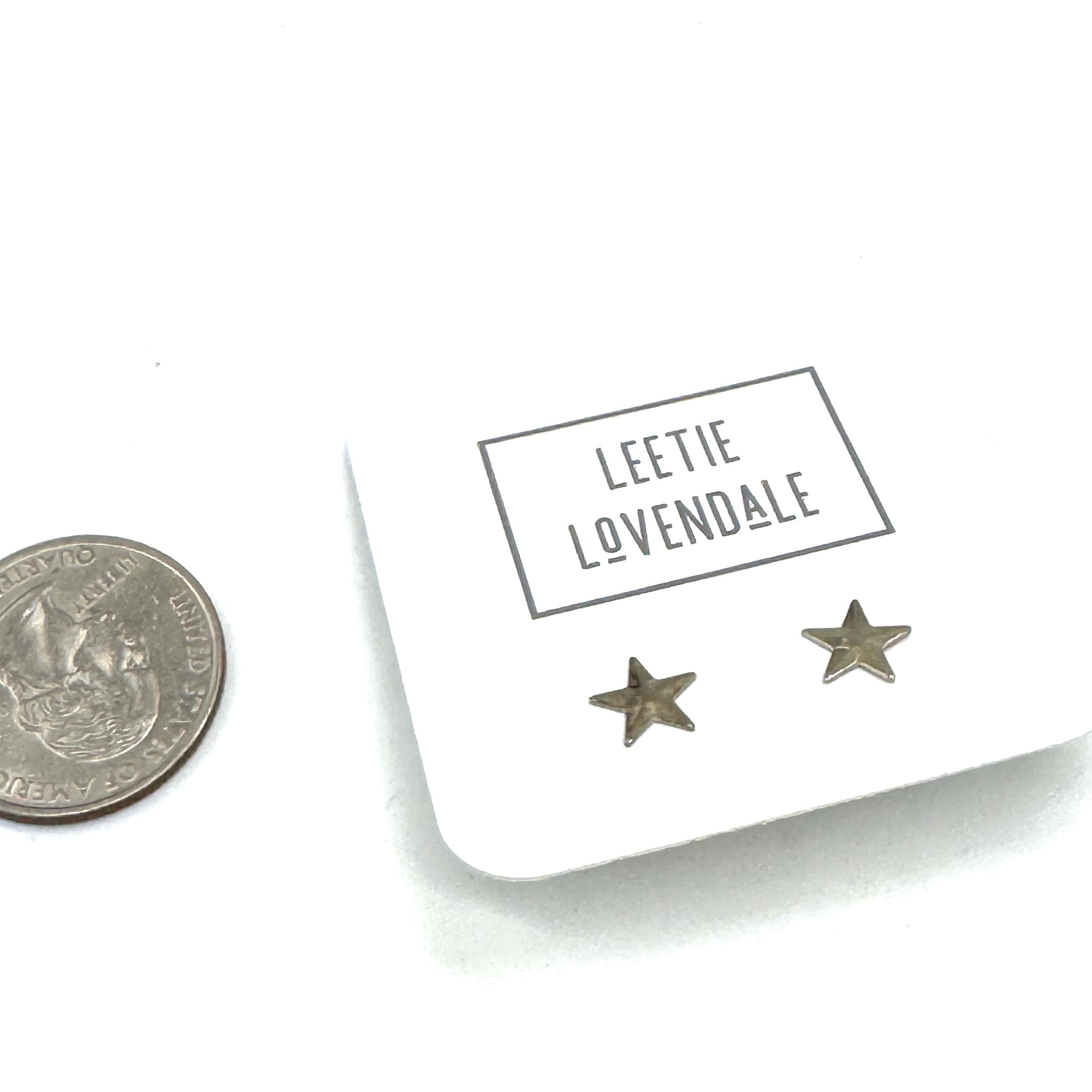 Star-shaped earrings on a card with &