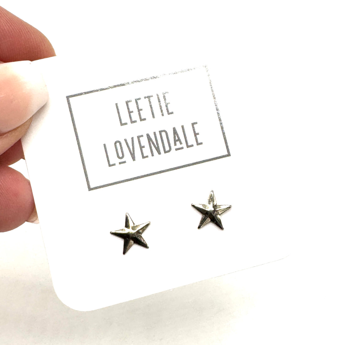 Star-shaped earrings on a card with &