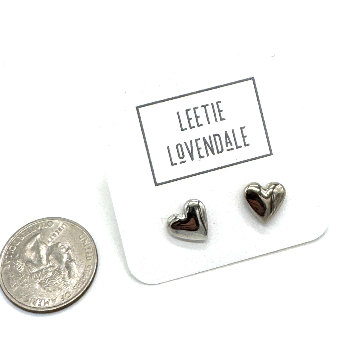 Heart-shaped earrings on a card with &