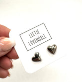 Heart-shaped earrings on a card with &