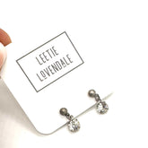 Pair of earrings on a white card with &