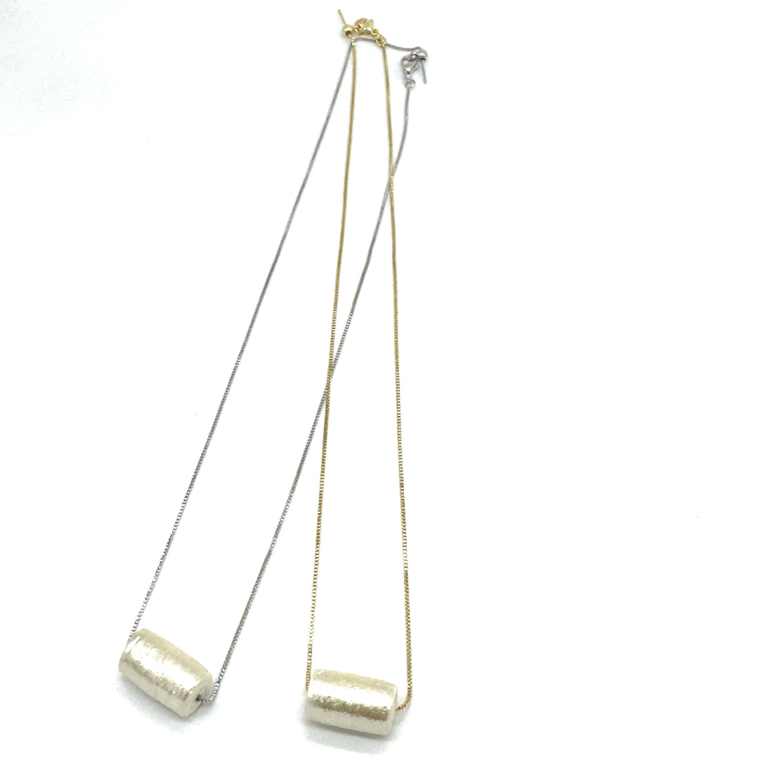 Two necklaces with tubular pearl pendant on a white background