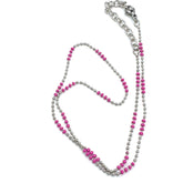 Necklace with pink and silver beads on a white background