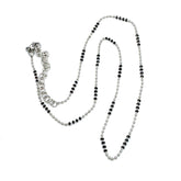 Silver necklace with black beads on a white background