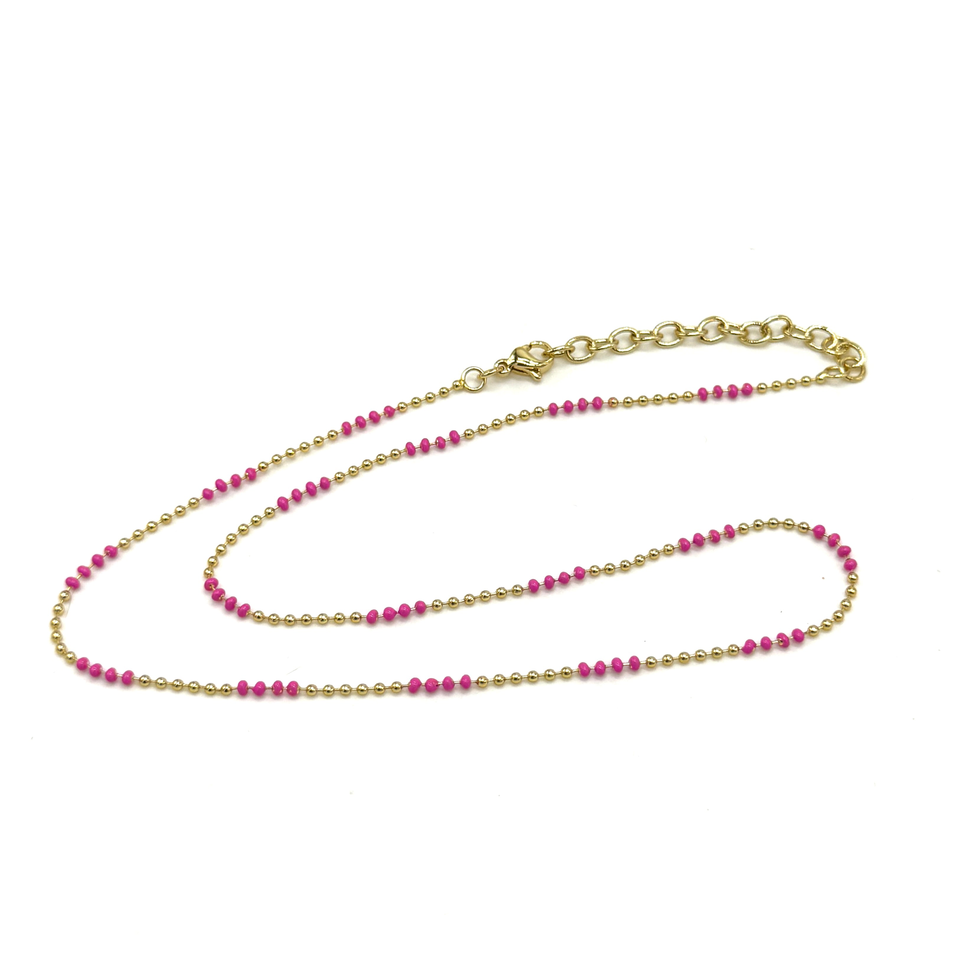 Gold and pink beaded necklace on a white background