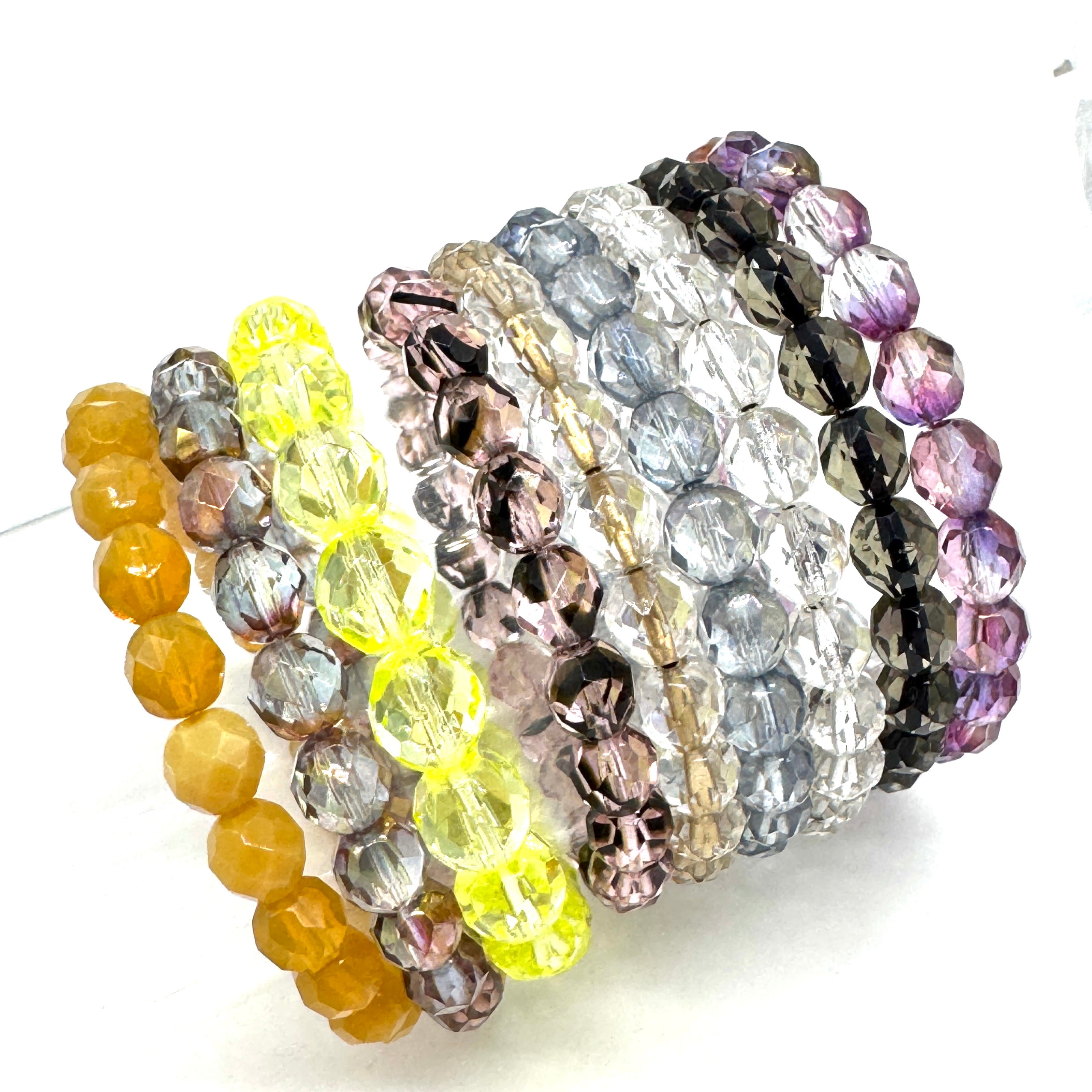 Set of colorful beaded bracelets on a white background