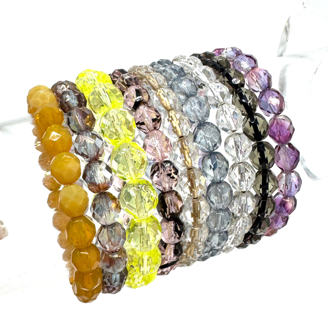 Set of colorful beaded bracelets on a white background