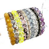 Set of colorful beaded bracelets on a white background