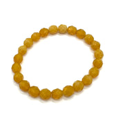 Yellow beaded bracelet on a white background