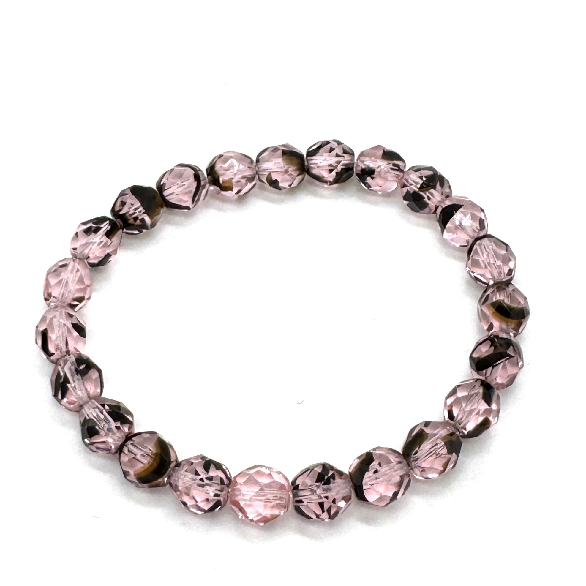 Bracelet with pink and black beads on a white background