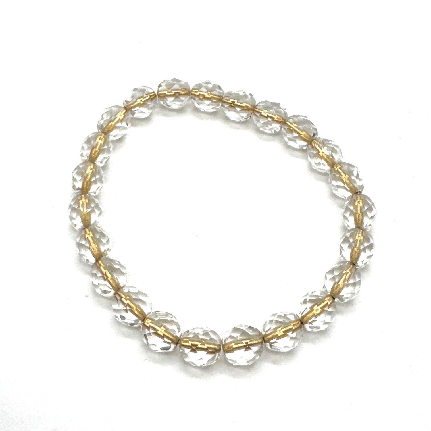 Gold and clear beaded bracelet on a white background