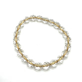 Gold and clear beaded bracelet on a white background