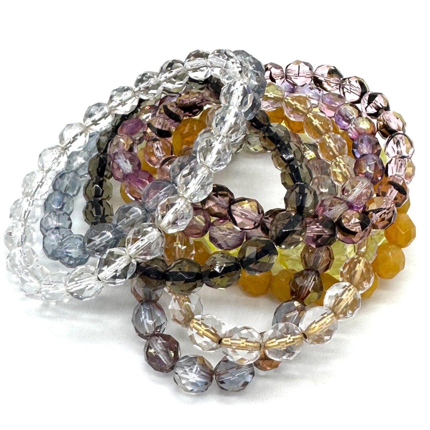 Set of multicolored beaded bracelets on a white background