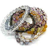 Set of multicolored beaded bracelets on a white background