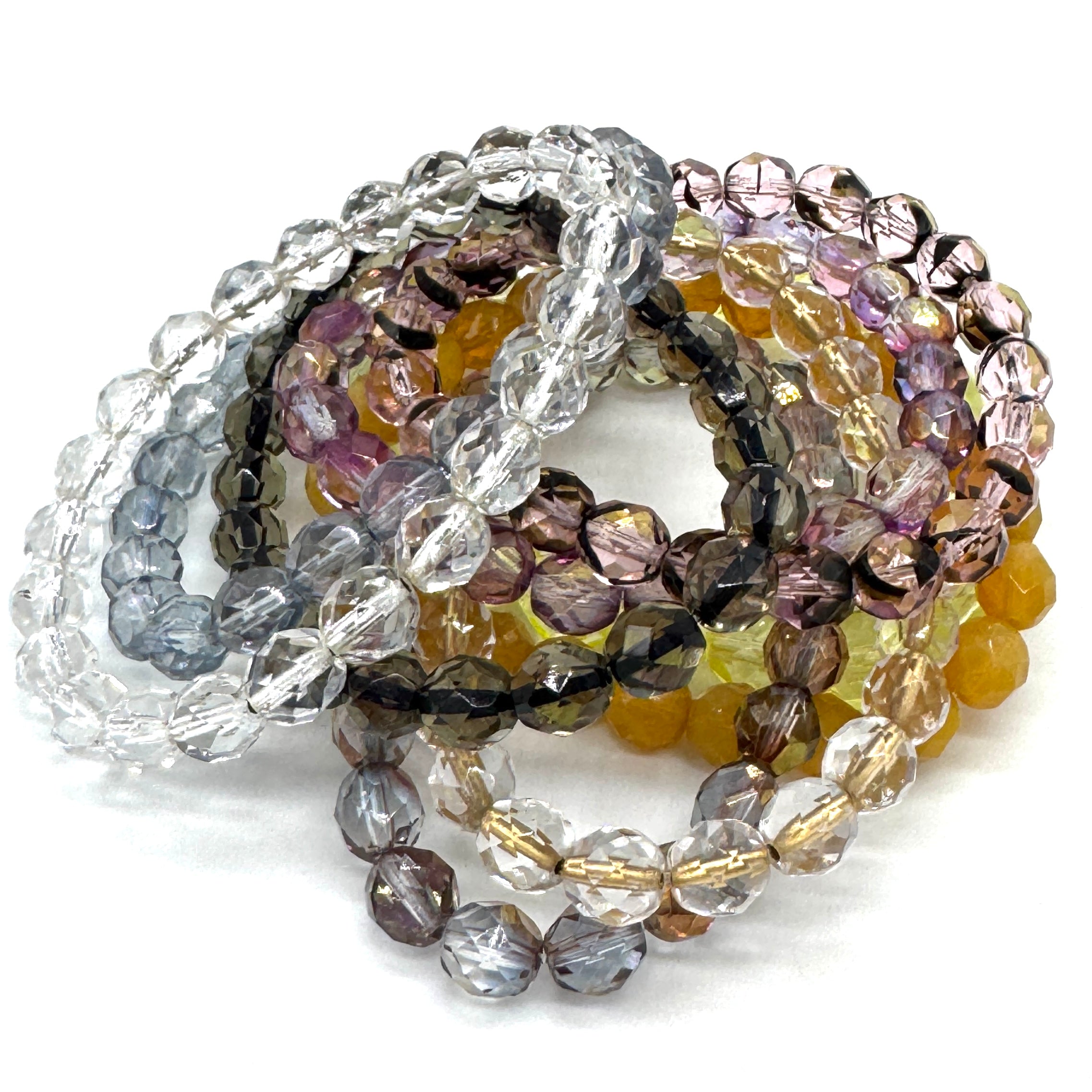 Set of multicolored beaded bracelets on a white background