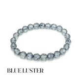 Blue luster beaded bracelet on a white background