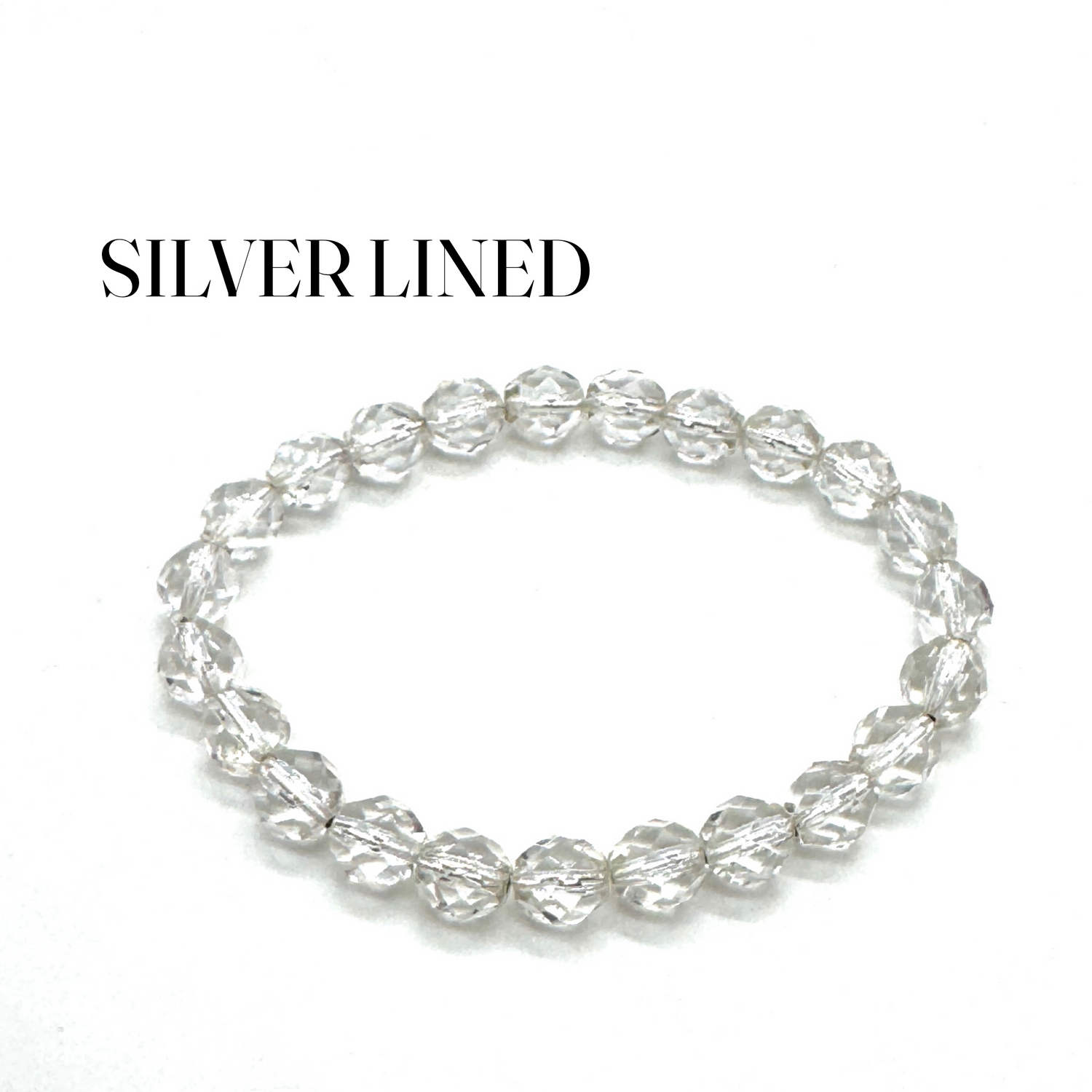 Silver beaded bracelet on a white background with &