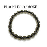 Beaded bracelet with black-lined smoke finish on a white background