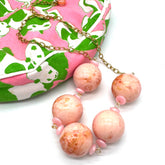 Necklace with pink and gold beads on a white background