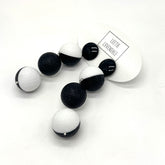 Black and white earrings on a white background with &