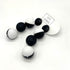 Black and white earrings on a white background with &
