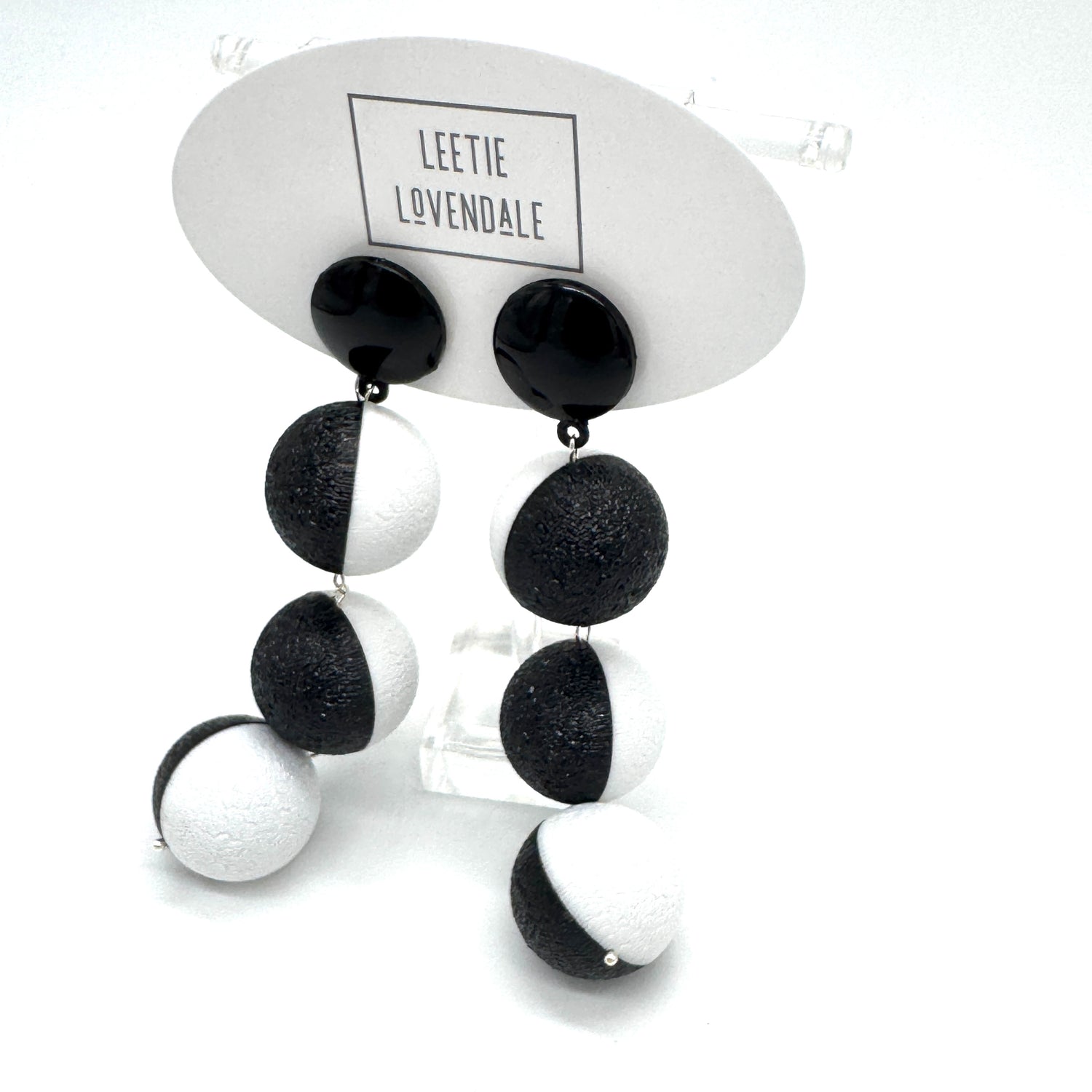 Black and white earrings on a Leetie Lovendale branded card