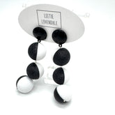 Black and white earrings on a Leetie Lovendale branded card