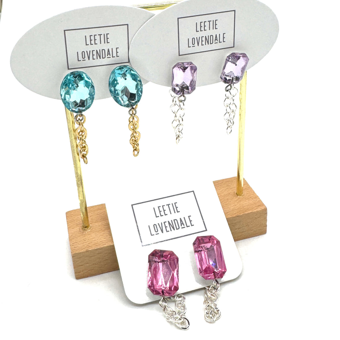 Earrings with colorful gemstones on display cards with &