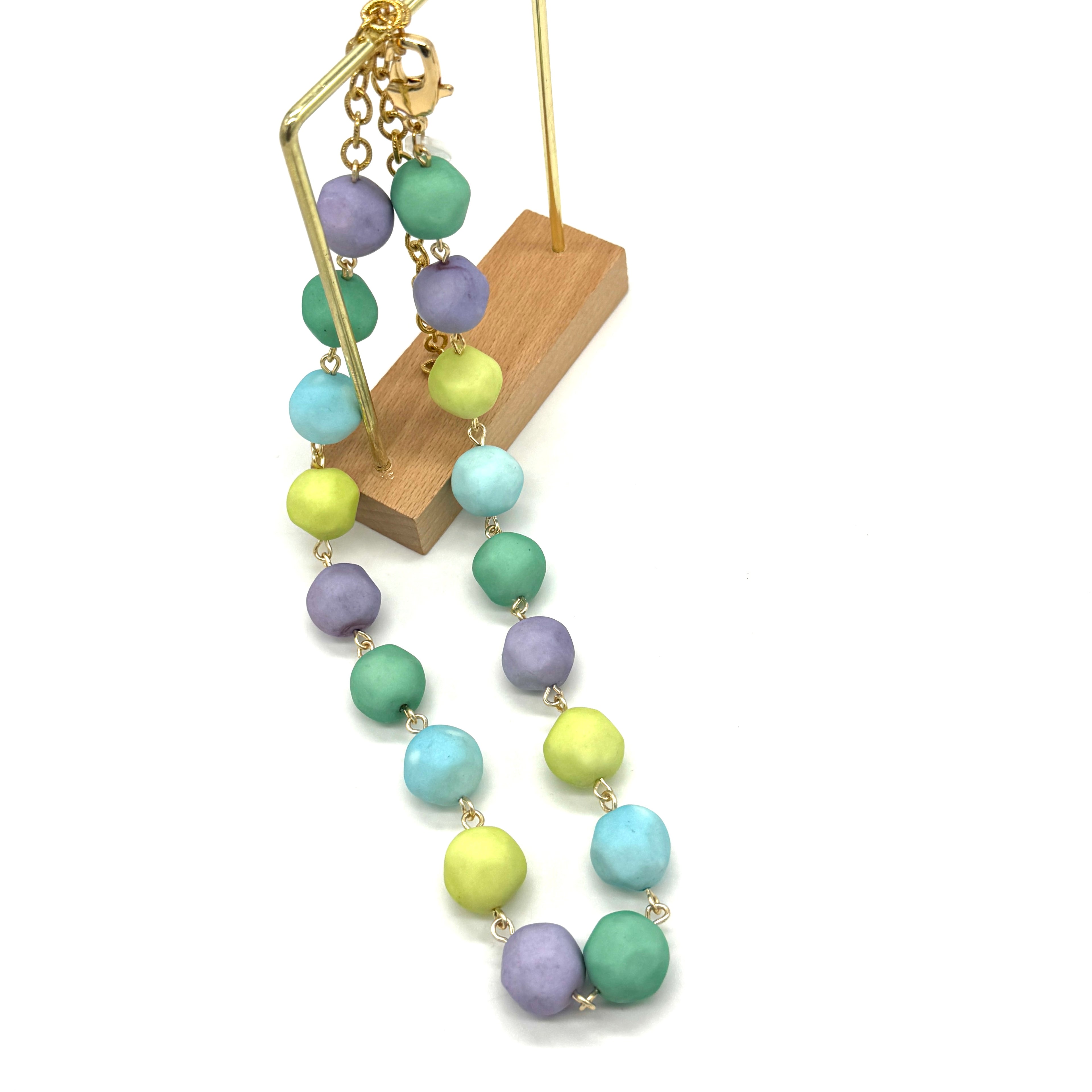 Necklace with pastel-colored beads on a white background