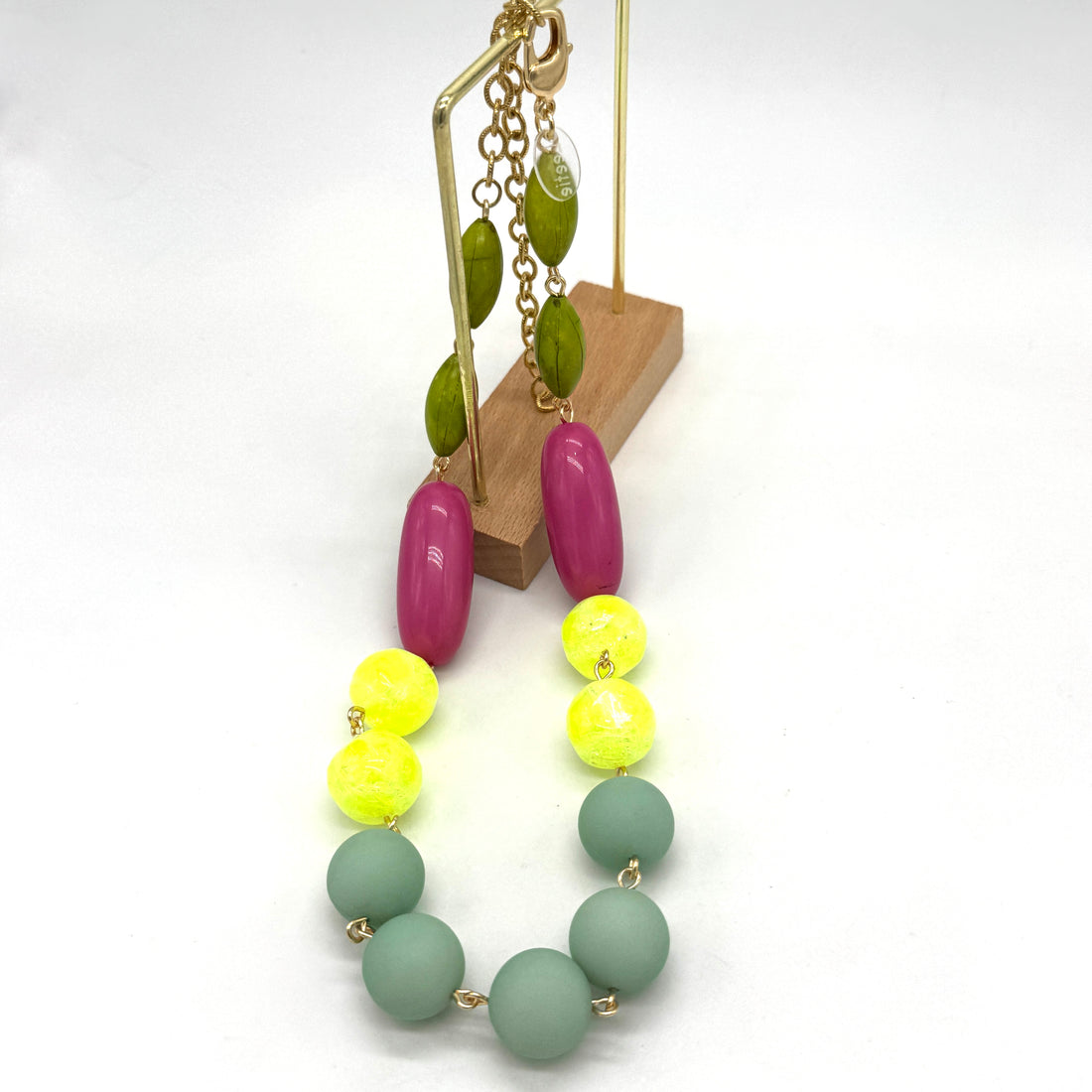 Neon green, yellow, and pink beaded necklace on a white background