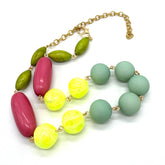 Colorful beaded necklace with gold chain on a white background