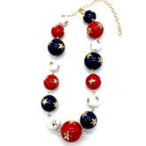 Necklace with red, blue, and white beads on a white background