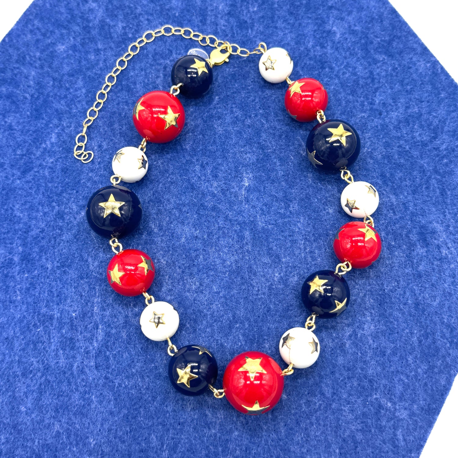 Bracelet with red, white, and blue beads on a blue background