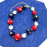 Bracelet with red, white, and blue beads on a blue background