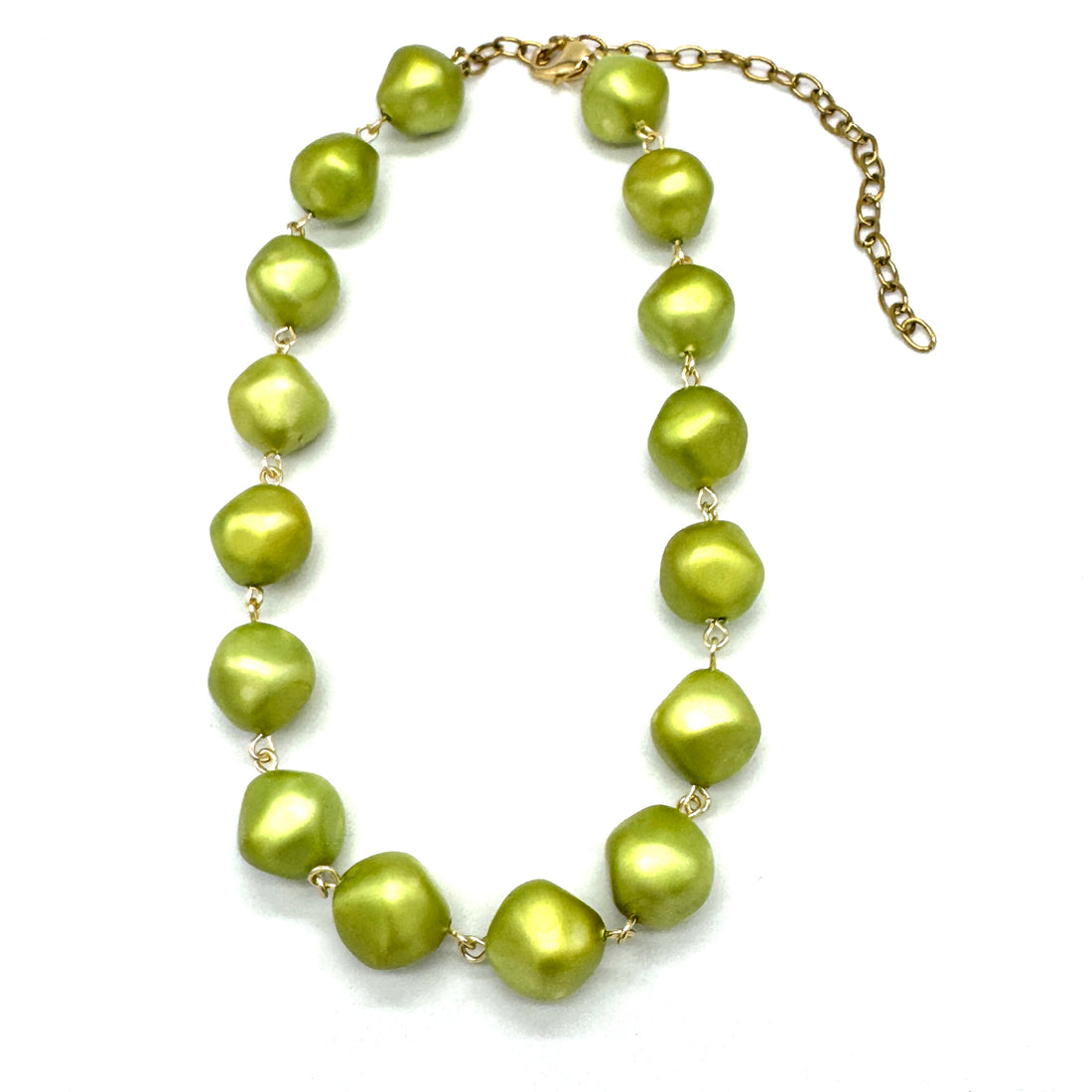 Necklace with green pearly beads on a white background