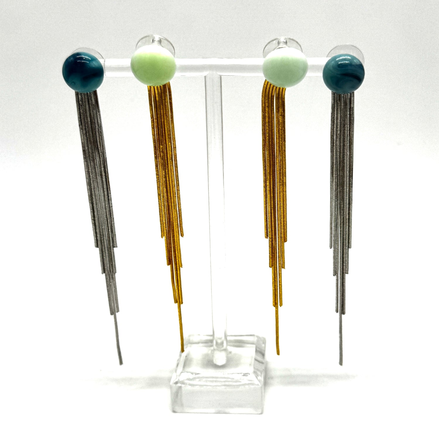 Pair of long earrings with colorful beads on a white background