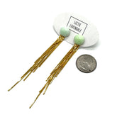 Gold fringe earrings with green beads on a white background, Leetie Lovendale branding visible.